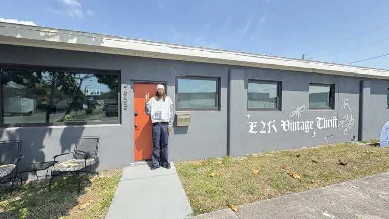 A business owner in front his shop