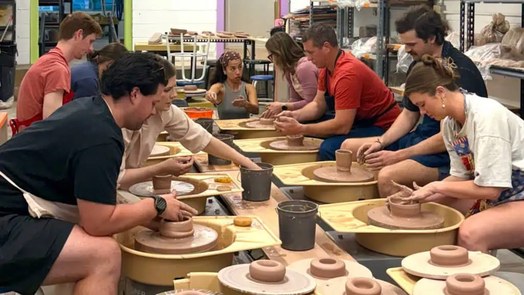 People molding clay