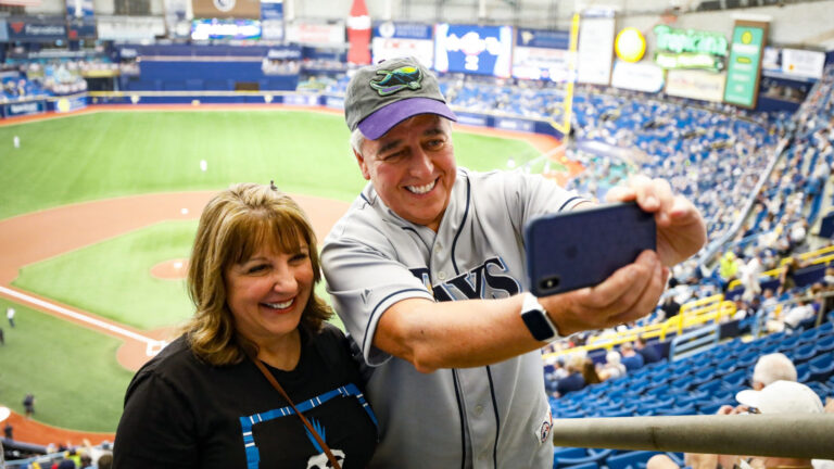 Two fans taking a selfie at a baseball game