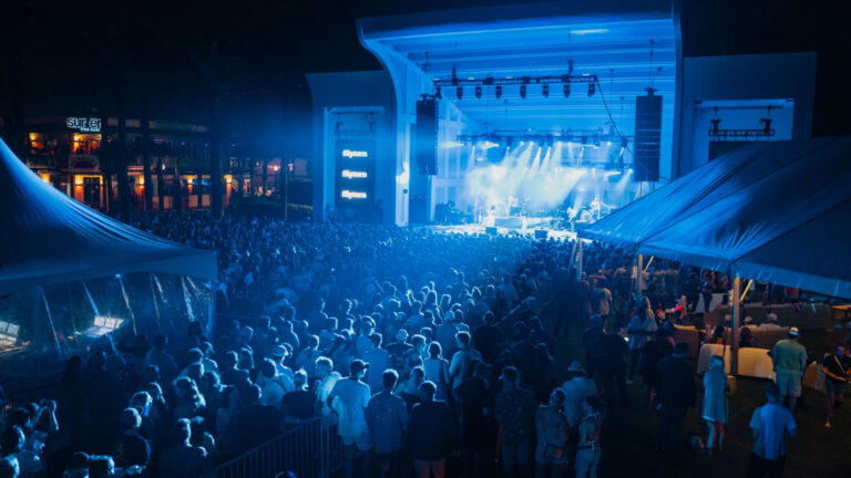 a crowd of epople in front of a fin fest satge
