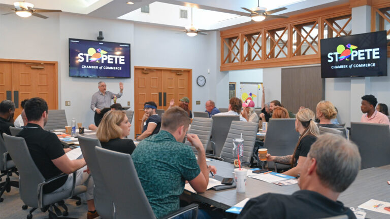 The Chef’s Circle Forum taking place in a conference room at the St. Pete Area Chamber of Commerce, with attendees seated around a large table listening to a presenter.