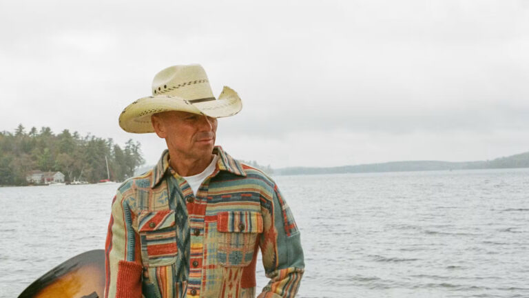Kenny Chesney holding a guitar
